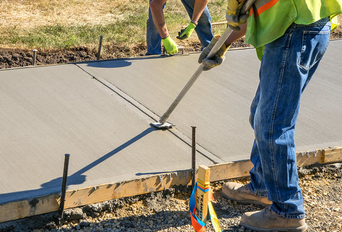 santa-barbara-sidewalk-construction-700 Construction men adding finishing touches to a concrete sidewalk